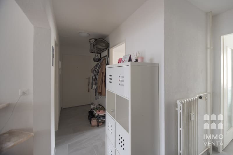 white walls, white floor, white storage unit, white radiator, white door, white ceiling light