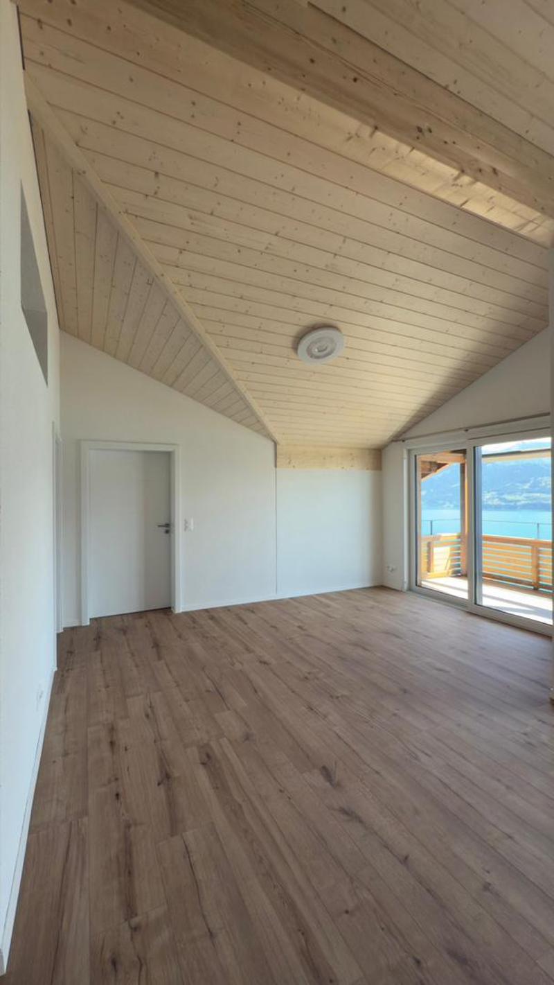 empty room, wooden floor, white walls, wooden ceiling, sliding glass door, balcony, view of the lake