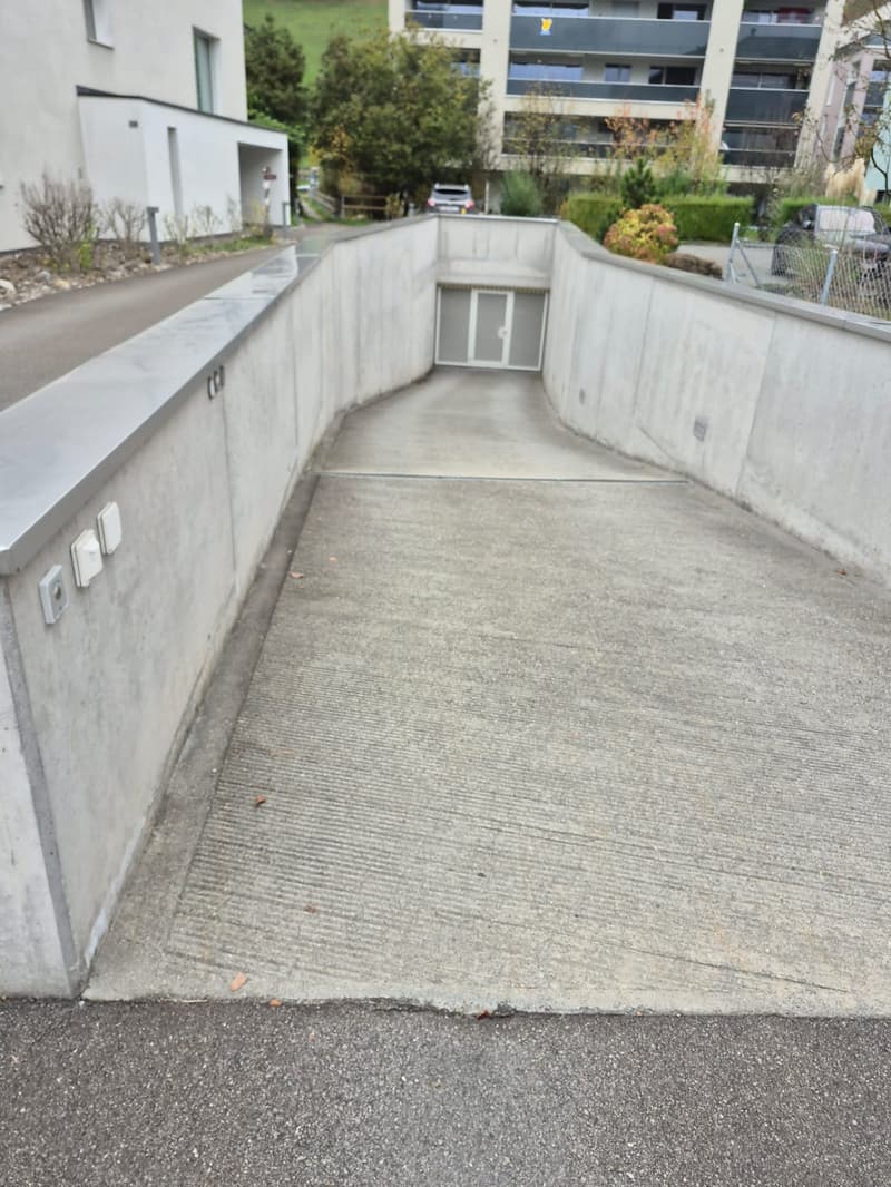 Concret entrance to the garage with a ramp