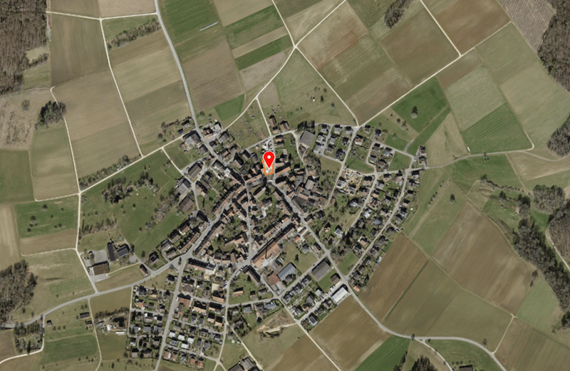 Aerial map of the village of Niederbuchsiten, featuring houses and roads surrounded by agricultural fields.