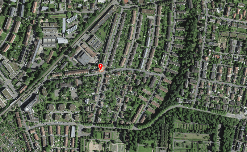 Aerial view of a residential area with many houses, trees, and roads.