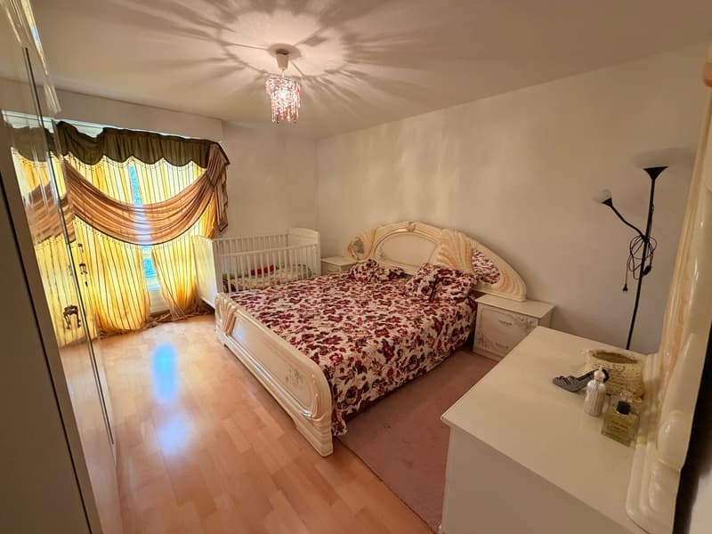 king-size bed, crib, carpet, floor lamp, white cabinets, yellow curtains