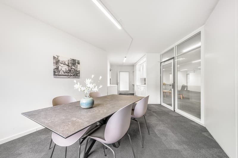 modern dining room, gray carpet, large wooden table, modern chairs, modern art piece