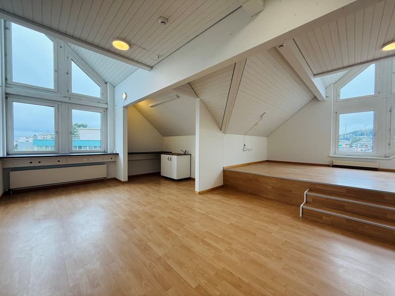 empty room, wooden floor, white walls, large windows, wooden steps, radiators, small kitchen area