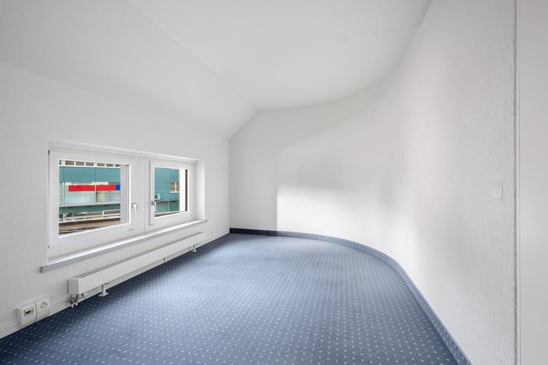 empty room, white walls, blue carpet, two windows, power outlets, heating