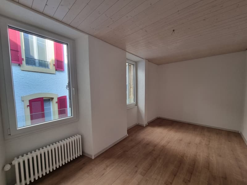 white walls, hardwood floor, white radiator, balcony with window