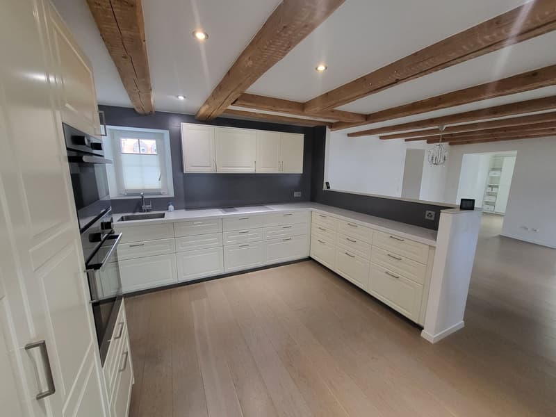 modern kitchen, wooden beams, white cabinets, sink, oven, microwave, wooden floors, modern ceiling