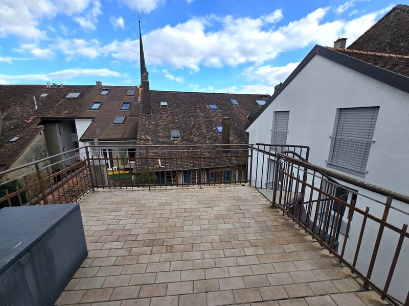 tiled floor, metal railing, storage box, view of the city