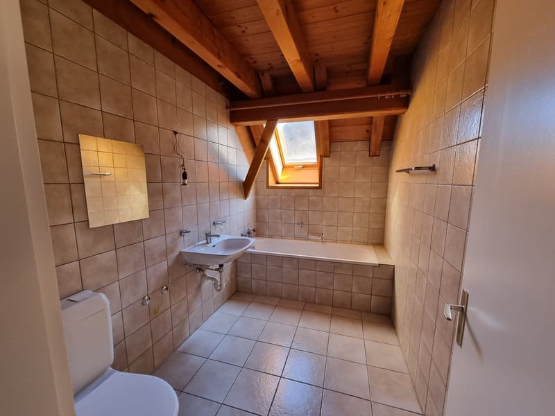 Bathroom with toilet, sink, bathtub, and wooden ceiling
