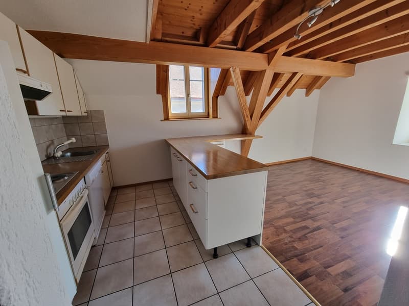 modern kitchen with wooden ceiling, white cabinets, tiled floor, stainless steel sink, oven, and dishwasher