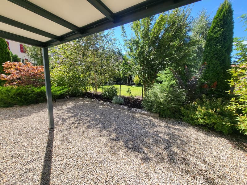 gravel driveway, trees, shrubs, garden, swing, house in background