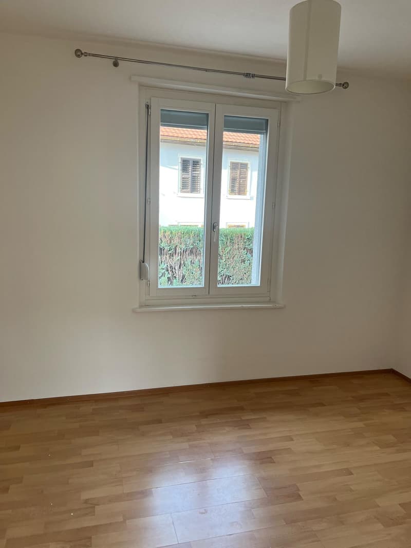 empty room, large window, wooden floor, white walls, white curtain rod, lamp