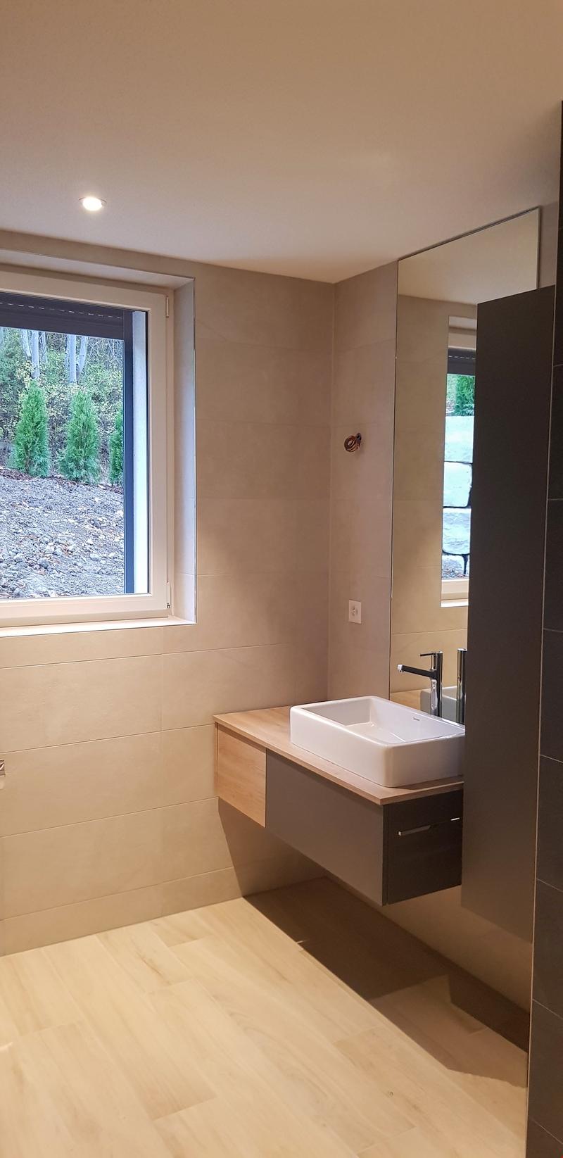 Bathroom with sink, mirror, window, wooden flooring, and wall tiles