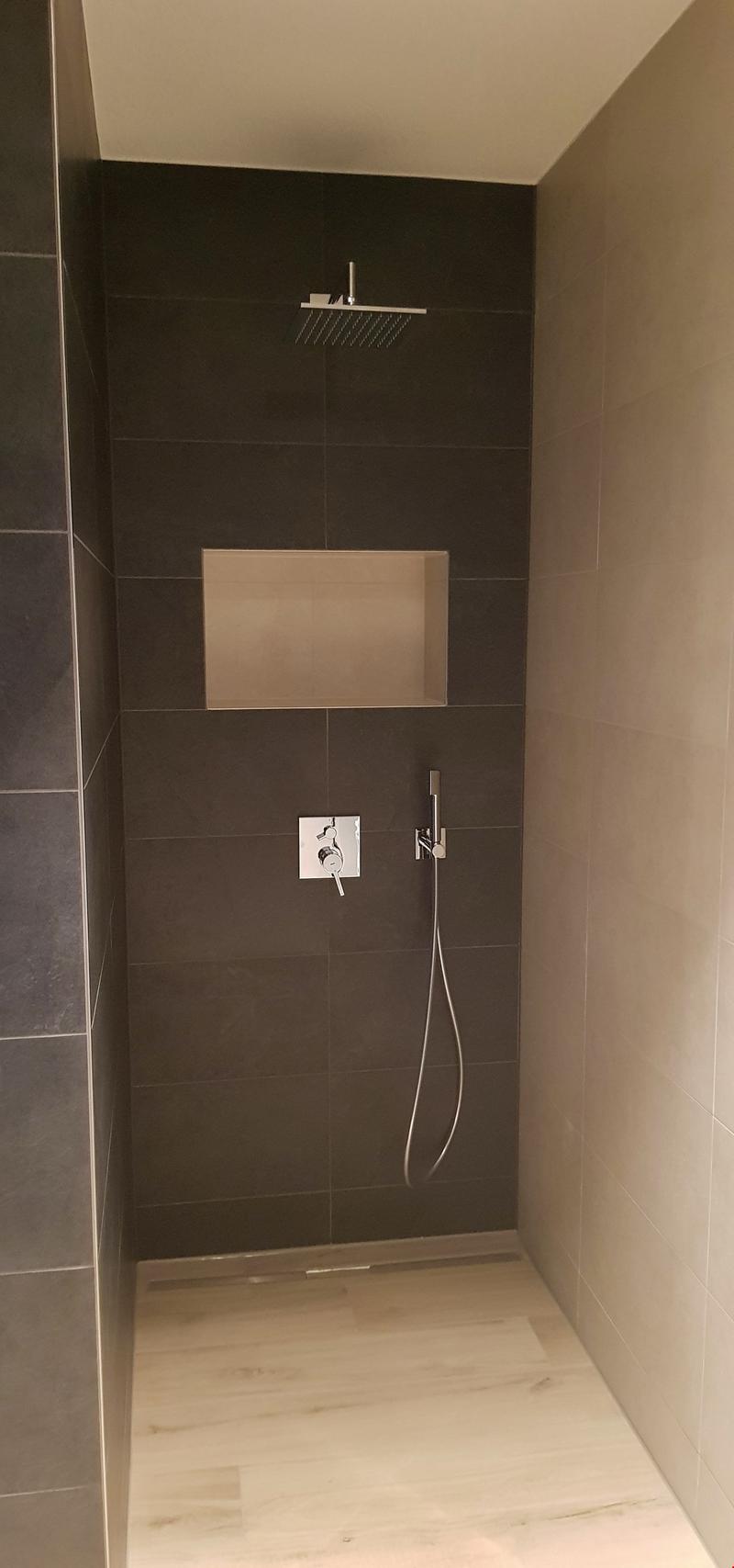 tiled walls, shower, shower head, wall mounted faucet, wooden floor