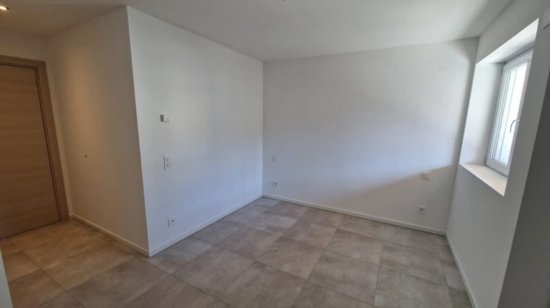 tiled floor, white walls, wooden door, power outlets, window