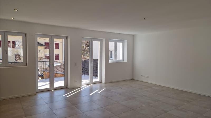 Empty room with balcony, tiled flooring, glass sliding doors, power outlets