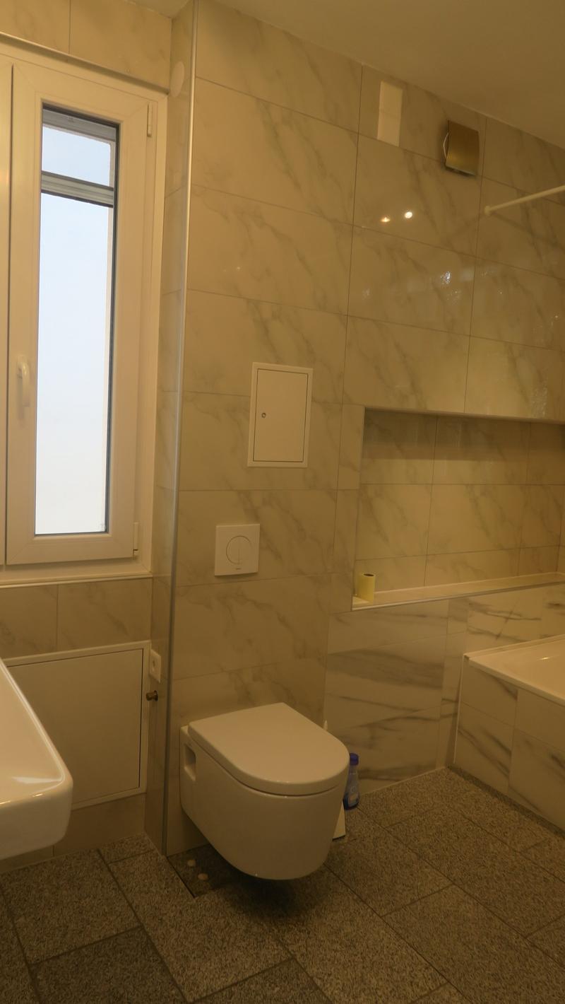 modern bathroom, white tiles, white toilet, white sink, bathtub, window