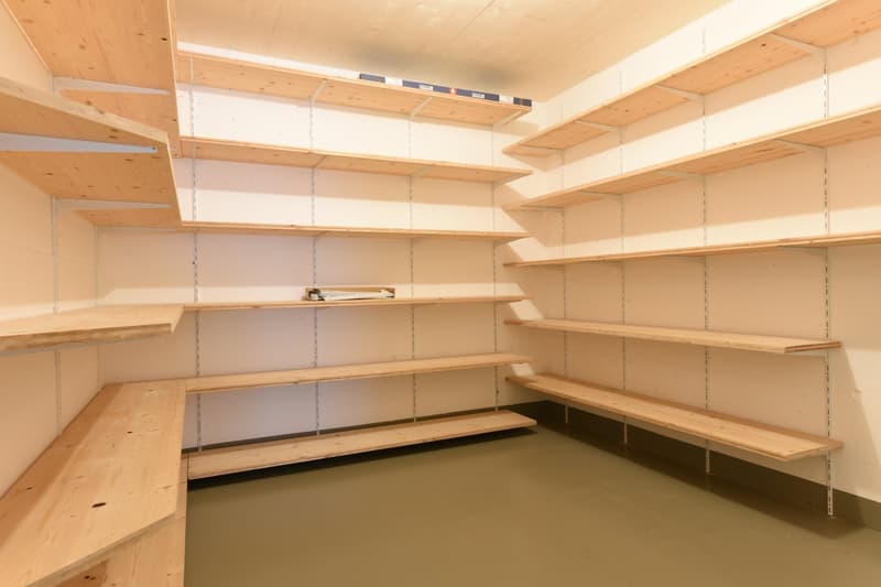 empty room with wooden shelves on the walls