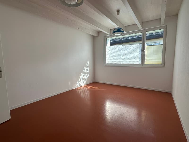 empty room, white walls, brown floor, window, ceiling lamp