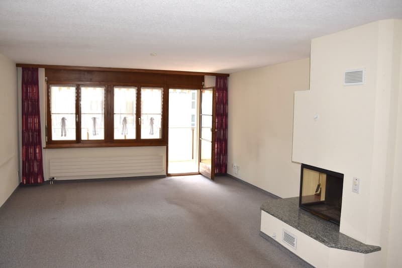 empty room, fireplace, large window, wooden door, carpeted floor