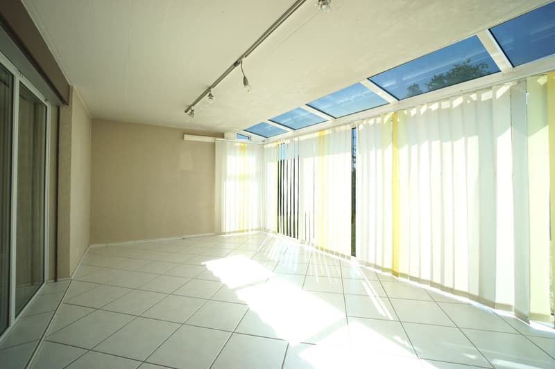 balcony, white tile flooring, large windows, bright sunlight, venetian blinds
