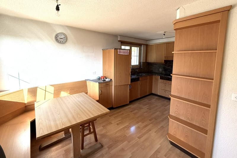 wooden table, wooden bench, wooden kitchen cabinets, light fixtures