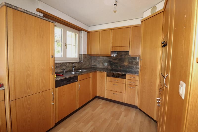 wooden cabinets, granite countertops, stainless steel sink, gas stove, dishwasher, wooden floor
