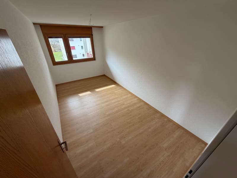 empty room, wooden floors, white walls, window, sun shining in