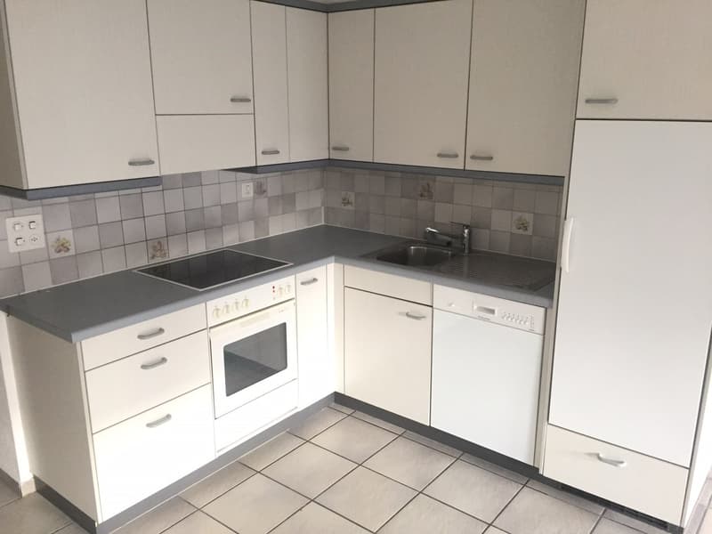 modern kitchen with white cabinets, tiled floor, stainless steel sink, electric oven, dishwasher, refrigerator