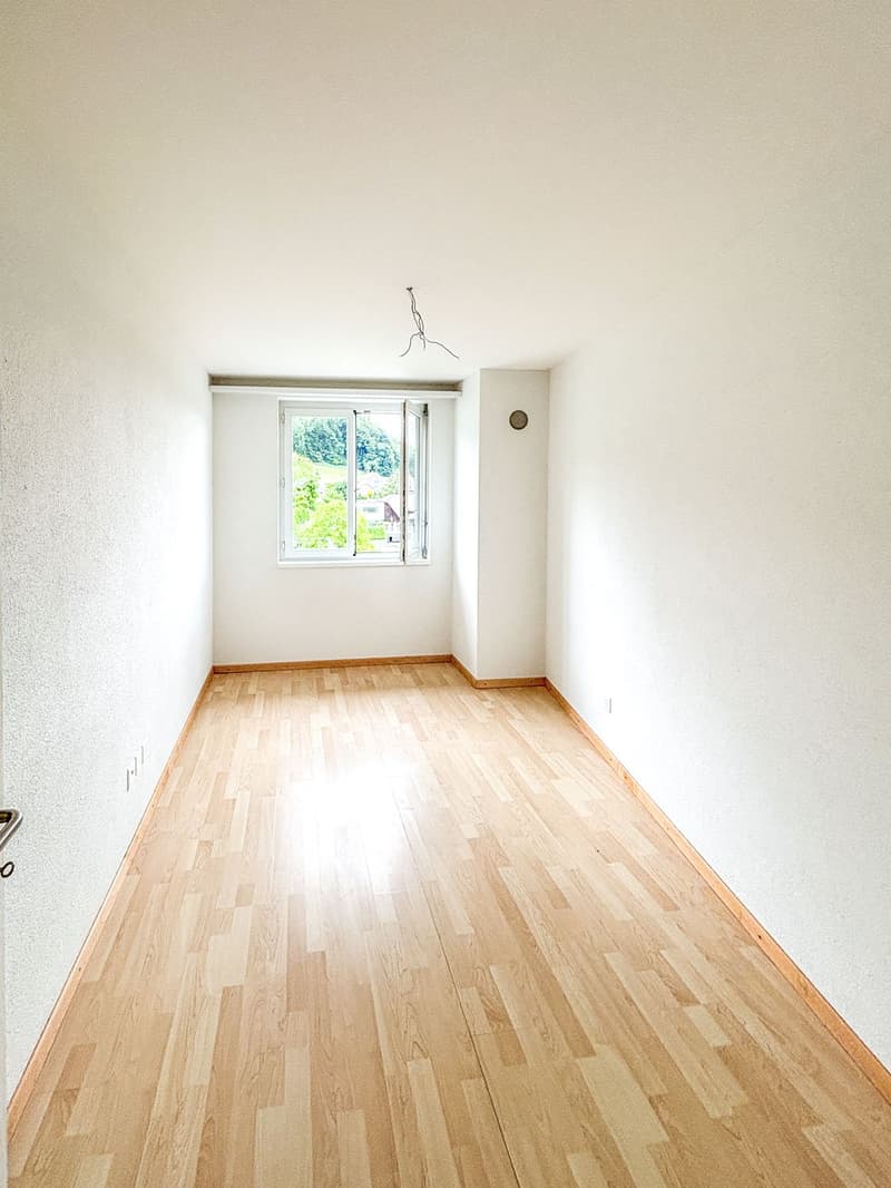 empty room, wooden floor, white walls, window, power outlet