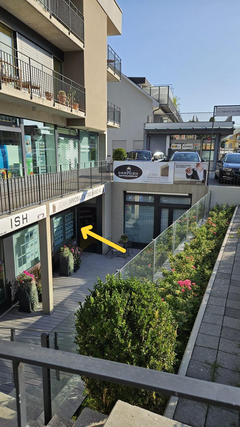 multi story house, glass windows, small balcony, black railings, metal door