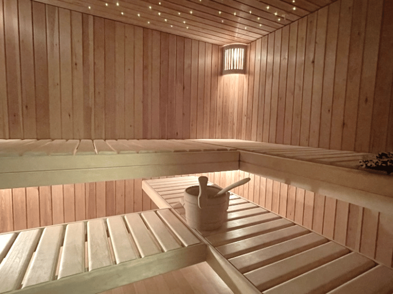 wooden sauna with benches, wooden bucket, wooden ladle, wooden wall, wooden ceiling