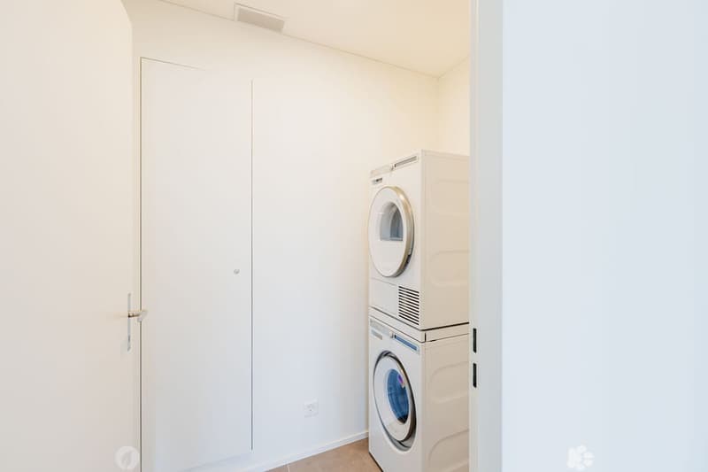 white walls, floor washing machine and dryer, white door