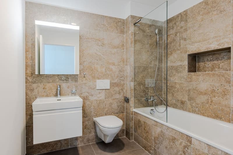 white sink, white toilet, walk-in shower, bathtub, mirror, tiled floor and walls