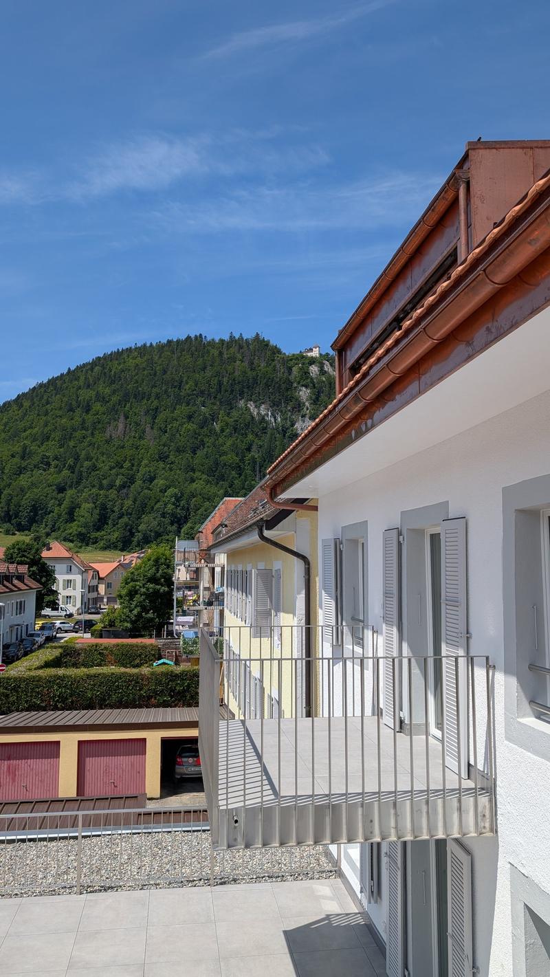 Building exterior with balcony and mountain view