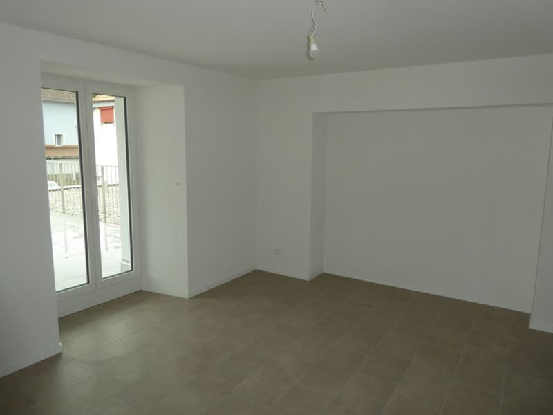 Empty room with white walls, large windows, and beige tile flooring.