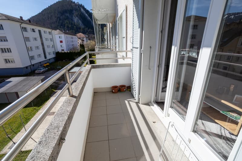 tiled floor, metal railing, potted plants, view of the mountains
