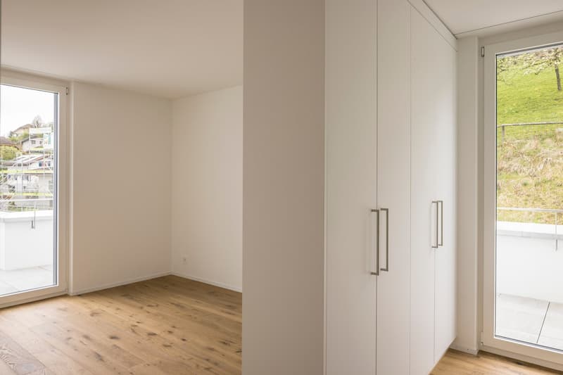 empty room, wooden floor, white walls, sliding glass doors, balcony, large windows