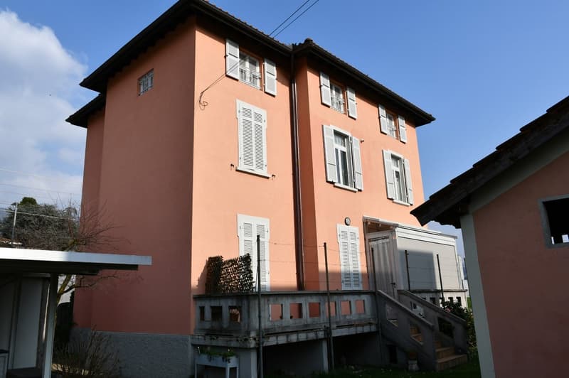 2 story house, peach paint, white shutters, balcony, staircase