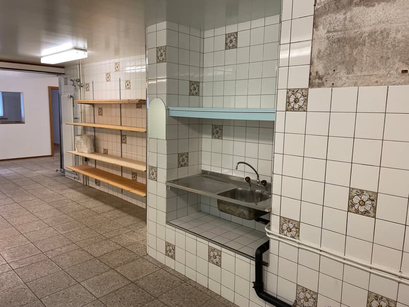Tiled kitchen with shelves, sink, and appliances