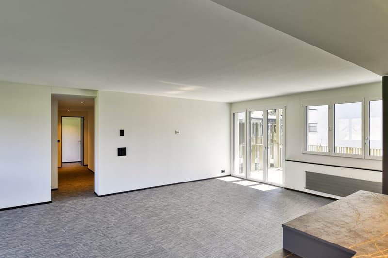 empty room, white walls, gray floor, sliding glass doors, balcony
