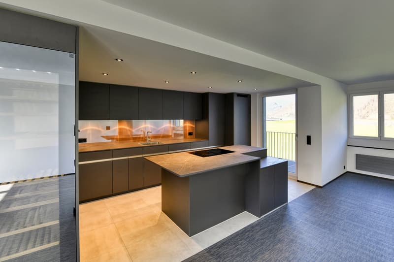 modern kitchen with island, granite countertops, built-in appliances, large windows, balcony
