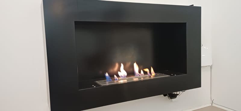 black fireplace, mounted on wall, with flames