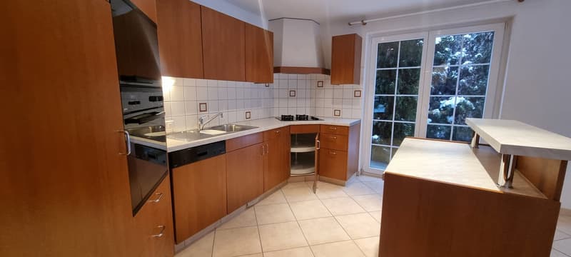 modern kitchen with wooden cabinets, white tiled floor, stainless steel appliances, dishwasher, gas stove, sink, large window