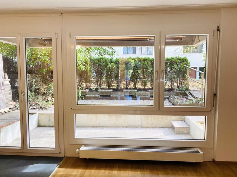 sliding glass doors, white walls, white floor, white ceiling, windows with outside view