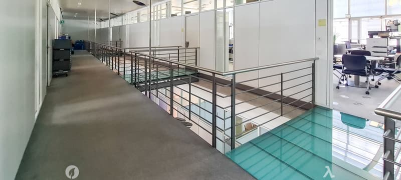 Long corridor, raised ground floor, glass railing, glass floor, white walls