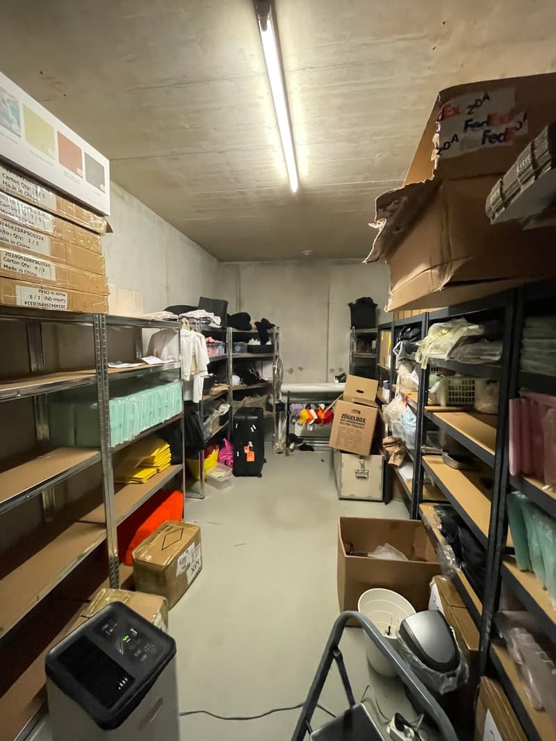 Storage room with shelves, boxes, and various items