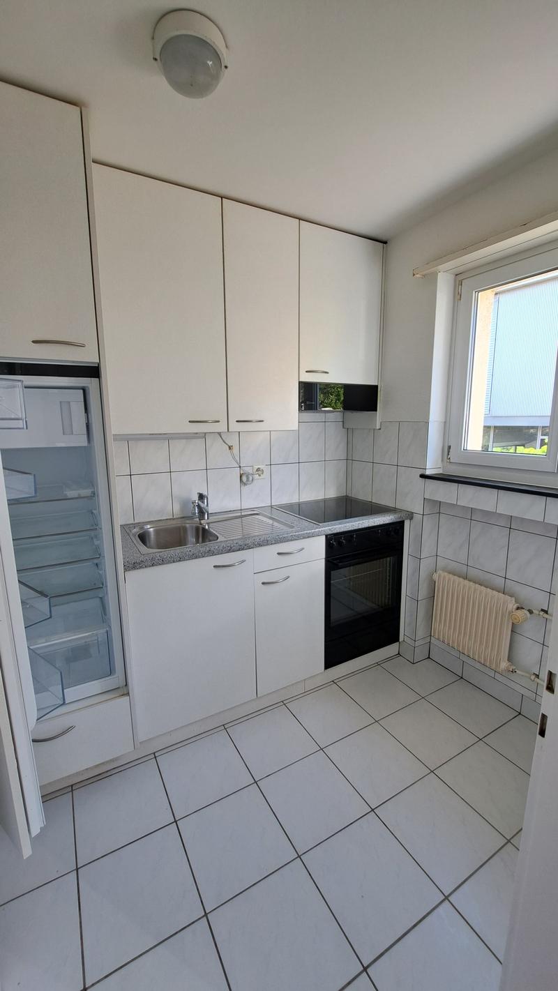 modern kitchen with white cabinets, tiled floor, sink, oven, refrigerator, dishwasher, white ceiling