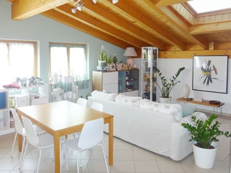 white couch, wooden table, white chairs, wooden ceiling, white floor, plants, shelves, lamp