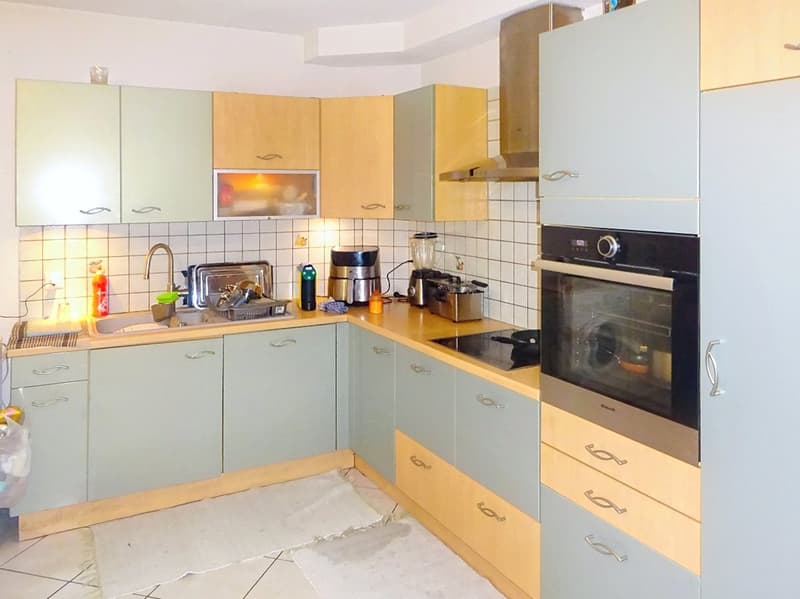 modern kitchen with wooden cabinets, tiled walls, stainless steel appliances, sink, faucet, and dishwasher